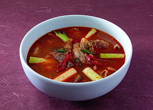 red soup on white ceramic bowl